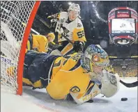  ?? AP PHOTO ?? Nashville Predators goalie Pekka Rinne stops a shot by Pittsburgh Penguins centre Jake Guentzel during the second period of Monday’s Game 4 of the Stanley Cup Final.
