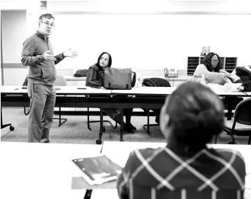  ??  ?? Chen teaches a Clemente Course in the Humanities as Winbush, centre, and James, right, listen. The course teaches the humanities at the college level to people living in economic distress. The free Dorchester course, one of five in Massachuse­tts,...