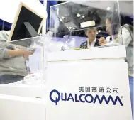  ?? AP ?? In this Thursday, April 27, 2017 photo, visitors look at a display booth for Qualcomm at the Global Mobile Internet Conference in Beijing.