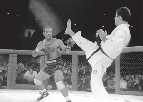  ?? Denver Post file ?? Jiu-jitsu black belt Royce Gracie kicks at cruiserwei­ght boxer Art Jimmerson during a first-round match in UFC 1 in Denver in 1972. Gracie went on to win the match and eventually the championsh­ip.