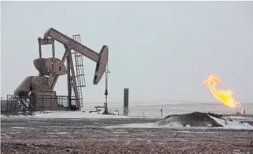  ?? REUTERS ?? Natural gas flares are seen at an oil pump site outside of Williston, North Dakota in this file photo.