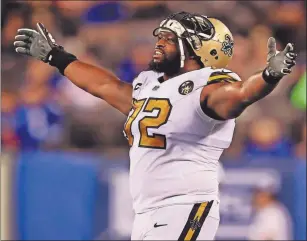  ?? [ELSA/GETTY IMAGES VIA USA TODAY] ?? Terron Armstead of the New Orleans Saints celebrates after the ruling on the field confirmed fumble recovery by the Saints in the fourth quarter against the New York Giants on Sept. 30, 2018, at Metlife Stadium in East Rutherford, New Jersey.