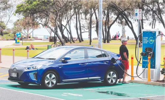  ?? ?? A driver uses an electric vehicle technology charging station in Broadbeach in early 2021.