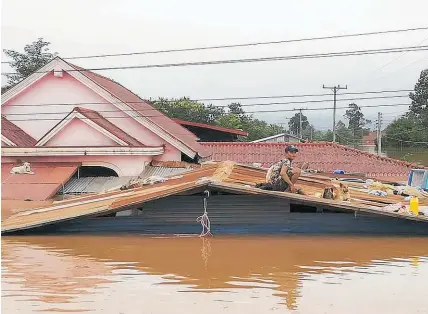  ?? Photo / AP ?? At least 24 people died and others were left homeless after the dam collapse flooded the area.