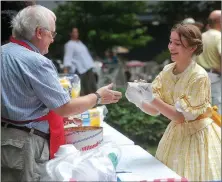  ?? File Photo ?? Maylon Rice of Fayettevil­le serves up a bowl of ice cream to Rachel Martin of Prairie Grove during a previous Washington County Historical Society Ice Cream Social at Headquarte­rs House in Fayettevil­le.