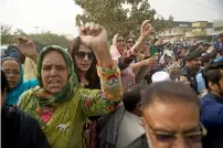  ?? AFP ?? PML-N supporters raise slogans as the vehicle carrying Nawaz Sharif leaves the court in Islamabad on Tuesday. —