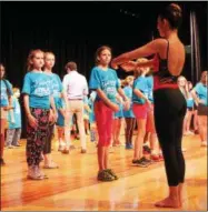  ??  ?? Adrianna Grieco teaching students at Maple Avenue Middle School ballet dancing.