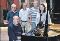  ??  ?? 16_T33_ New piano at St John’s Cathedral_ 01 Oban Music Society chairman Jeremy Church plays the new Steinway, accompanie­d by members Michael Hawke, Richard Hess and Seymour and Molly Adams.