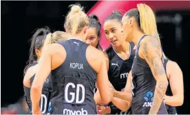  ??  ?? The Silver Ferns go into a huddle before the last quarter.