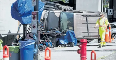  ?? DARRYL DYCK/THE CANADIAN PRESS ?? A man walks through a film set for the movie Deadpool 2 in Vancouver, B.C., on Tuesday. Production was halted after the death of a stuntwoman at a different filming location on Monday.