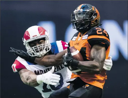  ?? — THE CANADIAN PRESS FILES ?? Lions’ Jeremiah Johnson (right) is tackled by the Als’ Henoc Muamba. Muamba has 100 defensive tackles, five sacks, a league-leading 11 tackles for losses, a forced fumble, and an intercepti­on this season.