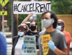  ?? Hearst Connecticu­t Media file photo ?? Members of the Cancel Rent Coalition and residents attend the Elm City Communitie­s/ Housing Authority announceme­nt of the cancellati­on of July rent during a news conference outside McQueeney Towers in New Haven on June 18.