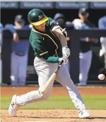  ?? Elaine Thompson / Associated Press ?? A’s shortstop prospect Nick Allen hits a solo home run against Seattle during a spring training game March 7.