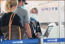  ??  ?? Travellers check in at a United Airlines kiosk with help from a United employee in the main terminal of Denver Internatio­nal Airport on Oct 1, in
Denver. (AP)