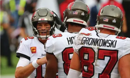  ?? Photograph: Kim Klement/USA Today Sports ?? Tom Brady is congratula­ted by Tampa Bay Buccaneers tight ends OJ Howard and Rob Gronkowski.