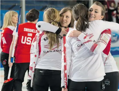  ?? ANDREW VAUGHAN/THE CANADIAN PRESS ?? From left, Ottawa’s Alison Kreviazuk, Rachel Homan, Lisa Weagle and Emma Miskew embrace after they defeated the United States 8-6 to win the bronze medal game at the world women’s curling championsh­ip in Riga, Latvia on Sunday.