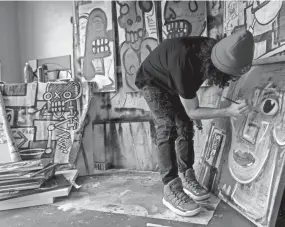  ?? HANNAH DIMMITT ?? Anthony Sims, 22, paints in his studio. The Southaven, Mississipp­i, native hopes to eventually use the money he's making from selling his art to create a museum of digital art in Memphis.