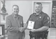 ?? Contribute­d photo ?? Cpl. Kevin Chandler (right) receives his Officer of the Year award from Dan Riley of the Cedartown Exchange Club.