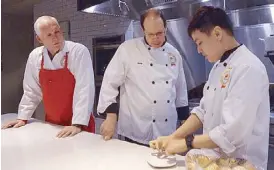  ??  ?? Chef Anton Amoncio (right) confers with Chef Marty Carpenter and Master Butcher Abe Van Melle of the Canada Beef Centre of Excellence