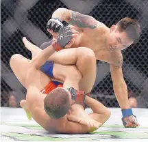  ?? JOHN LOCHER/ASSOCIATED PRESS ?? Ray Borg, top, fights Louis Smolka at UFC 207 last year. Borg thought he was in line to face flyweight champ Demetrious Johnson, but that might not happen.