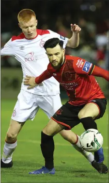  ??  ?? Adam Wixted holds off Shelbourne’s Shane Farrell.