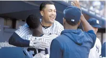  ?? AFP-Yonhap ?? Giancarlo Stanton of the New York Yankees celebrates his sixth inning home run against the Toronto Blue Jays in the dugout with teammates at Yankee Stadium, Saturday, in New York City.