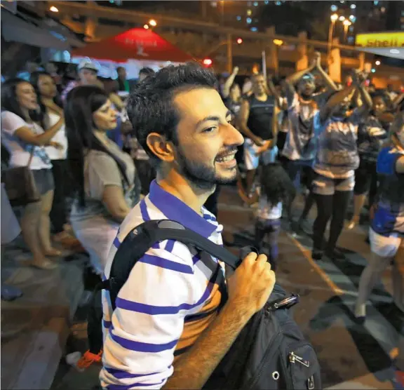  ??  ?? WAHIB HAYEK watches as members of the Escola de Samba Vai-Vai dance school parade through the streets in preparatio­n for the Carnival of Brazil. He hates the word “ref