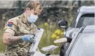  ??  ?? JULY 2020:
Military personnel help at a pop up Covid testing centre in Mixenden, Halifax.