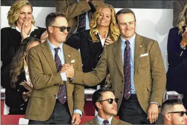  ?? PHOTOS BY CHARLIE NEIBERGALL/AP ?? Team USA’S Justin Thomas (left) and Jordan Spieth shake hands after it was announced they would play in the first group of today’s foursomes during the opening ceremony for the Ryder Cup on Thursday.