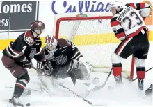  ?? CLIFFORD SKARSTEDT/EXAMINER ?? Peterborou­gh Petes' Matt Timms clears a rebound next to his goalie Dylan Wells and Ottawa 67s Shaw Boomhower during first period OHL action on Saturday night at the Memorial Centre. OHL 21 columnist Josh Brown suggests other OHL teams should follow...