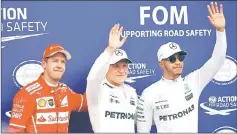  ??  ?? Mercedes’ Valtteri Bottas (centre) celebrates pole with Ferrari’s Sebastian Vettel finishing second and Mercedes’ Lewis Hamilton who will start eighth after being awarded a penalty. — Reuters photo