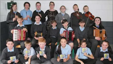  ??  ?? Pupils from the senior classes at Cullen National School who sang and played on their debut CD ‘A Medley of Music and Song’, pictured with School Principal Hannah Kelleher. The junior classes also participat­ed in the recording.