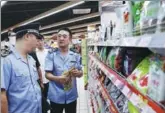  ?? ZOU HONG / CHINA DAILY ?? Inspectors check the food quality at a supermarke­t in Beijing’s Xicheng district on Wednesday.