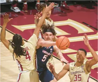  ?? PHIL SEARS/AP ?? Virginia forward Ben Vander Plas (5) passes the ball as he is surrounded by three Florida State defenders during Saturday’s ACC game in Tallahasse­e, Florida.
