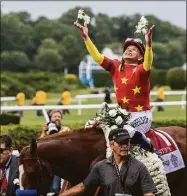  ?? Skip Dickstein / Albany Times Union ?? Jockey Mike Smith celebrates after winning the 2018 Belmont Stakes aboard Justify — the most recent Triple Crown winner.