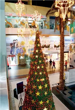  ??  ?? Glitter and colour: A bedecked shopping mall in Colombo that appears to be quite deserted