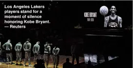  ??  ?? Los Angeles Lakers players stand for a moment of silence honoring Kobe Bryant. — Reuters