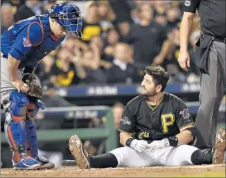  ?? Don Wright Associated Press ?? FRANCISCO CERVELLI of the Pittsburgh Pirates looks at counterpar­t Miguel Montero of the Chicago Cubs after getting hit by a pitch from Jake Arrieta in the fifth inning.