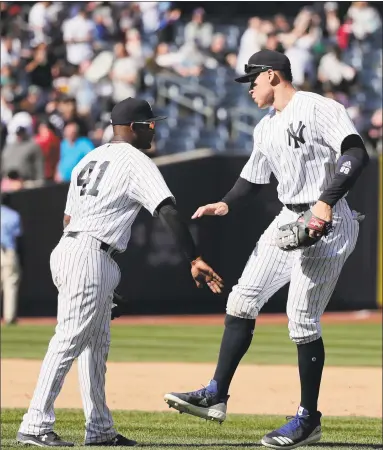  ?? Julie Jacobson / Associated Press ?? Yankees third baseman Miguel Andujar, left, and Aaron Judge celebrate after New York defeated the Blue Jays 9-1 on Saturday.