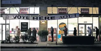  ?? AMERICAN-STATESMAN VIA THE ASSOCIATED PRESS] [JAY JANNER /AUSTIN ?? People wait in line to vote Tuesday in Austin, Texas, before the polls opened at 7 a.m.