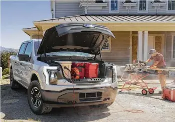  ?? Ford photo ?? Under the F-150 Lightning Pro hood is a 14-cu.-ft. “mega power frunk” that’s lockable, has a drain, four 120-volt AC outlets and two USB ports.