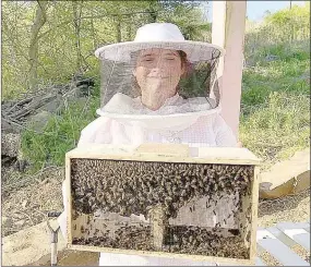  ?? COURTESY PHOTOS ?? Abbi Wilhite, a member of Lincoln High FFA Chapter, works her honeybees, a project made possible through a National FFA SAE Grant.