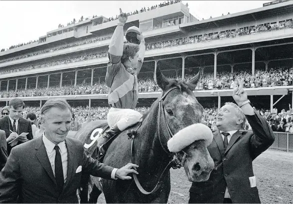  ?? THE ASSOCIATED PRESS/FILES ?? Jockey Bob Ussery, owner Peter Fuller, left, and trainer Louis C. Cavalaris Jr. celebrate with Dancer’s Image in May 1968 at the Kentucky Derby.