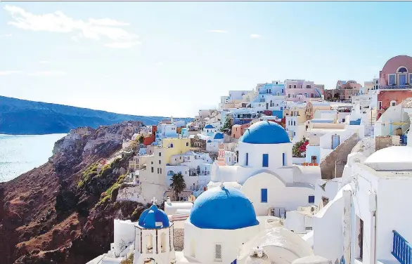  ?? TRISH FEASTER ?? The picture-perfect village of Oia in Santorini, resting a thousand feet high above a volcanic crater, is a dream come true for photograph­ers and sunset watchers.