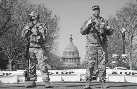  ?? JACQUELYN MARTIN/AP PHOTO ?? National Guard keep watch on the Capitol Thursday on Capitol Hill in Washington.