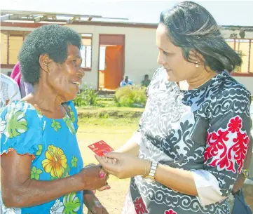  ?? Photo: Ministry of Women, Children and Poverty Alleviatio­n ?? Minister for Women, Children and Poverty Alleviatio­n Rosy Akbar (right), presents a Help for Home initiative e-card to Marica Naigisa in Rakiraki last week.