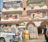  ?? HT PHOTO ?? Securityme­n stand guard outside the apartment in which the flat of the district welfare officer was raided in connection with the fund transfer scam, at Bhagalpur on Monday.