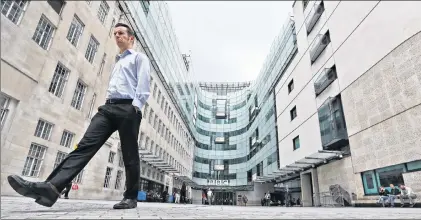  ?? AP PHOTO/FRANK AUGSTEIN ?? A man walks outside the main entrance to the headquarte­rs of the publicly funded BBC in London, Wednesday, July 19. The BBC published the names and salaries of its highest-earning actors and presenters, compelled by Britain’s government to publish the...