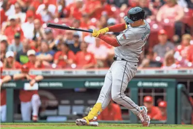  ?? KATIE STRATMAN/USA TODAY SPORTS ?? Arizona Diamondbac­ks designated hitter Joc Pederson hits a solo home run in the first inning of Thursday’s game against the Reds at Great American Ball Park in Cincinnati.