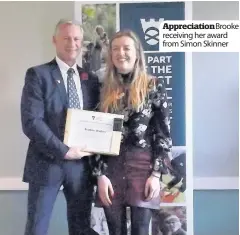  ??  ?? Appreciati­onBrooke receiving her award from Simon Skinner